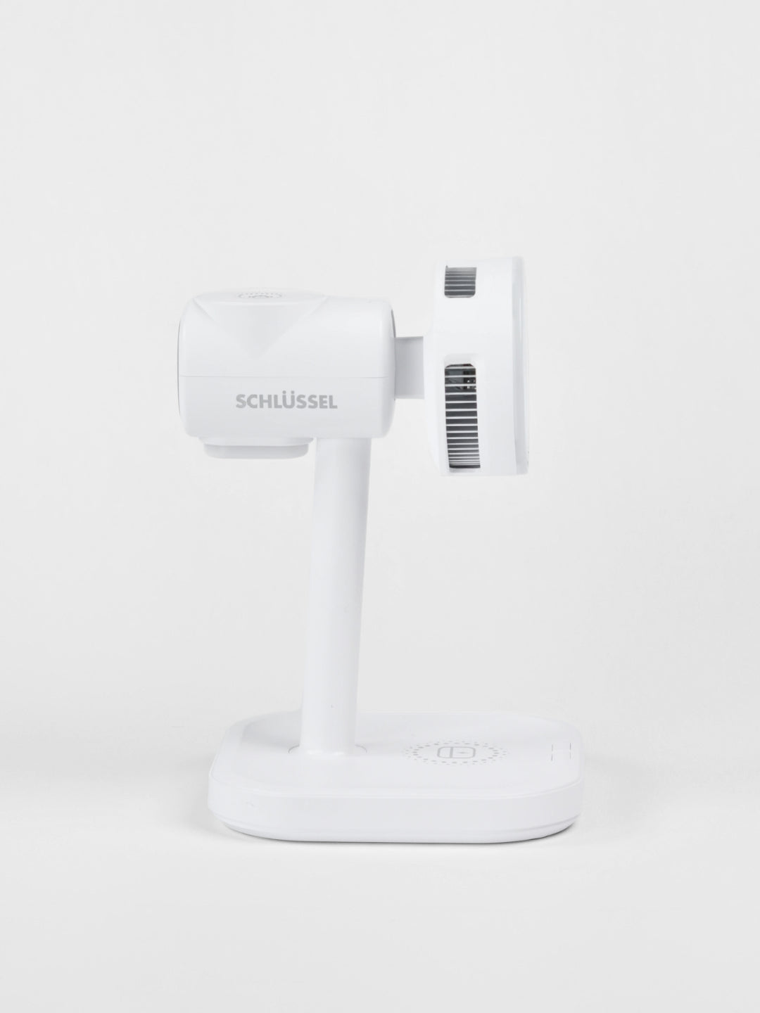 Side profile view of the white Schlüssel 3-in-1 wireless charging station, highlighting the brand logo, cooling ventilation vents, and flat charging base against a seamless gray background