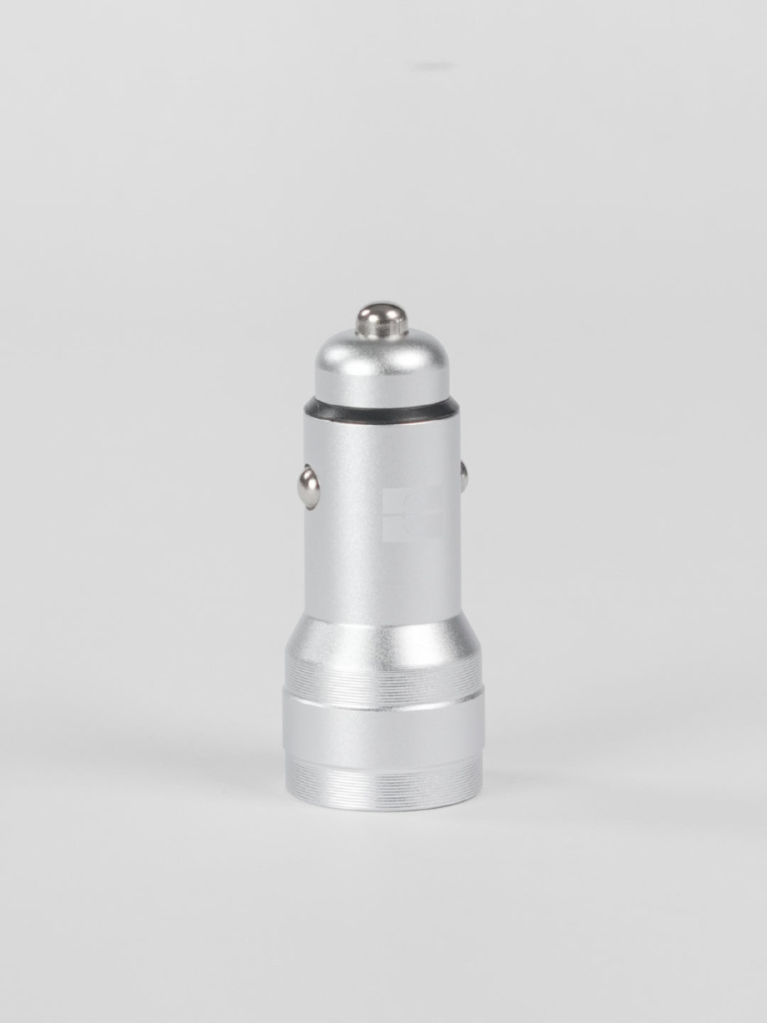 A standalone silver metallic Schlüssel car charger adapter standing vertically, showcasing its premium aluminum finish and metal contact points against a clean, light gray background.