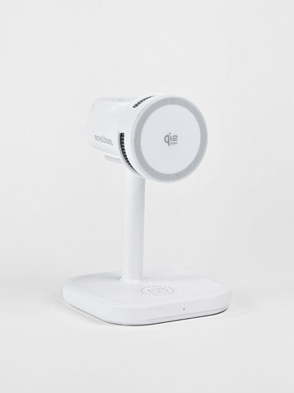 A standalone white Schlüssel 3-in-1 wireless charging station featuring a Qi2 15W magnetic phone mount, captured from a three-quarter angle against a neutral gray background